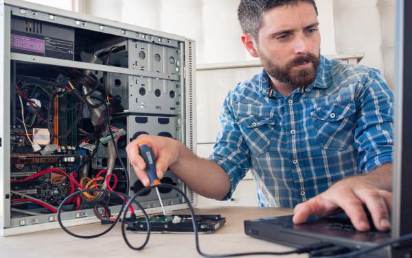 Man attempting to fix a computer