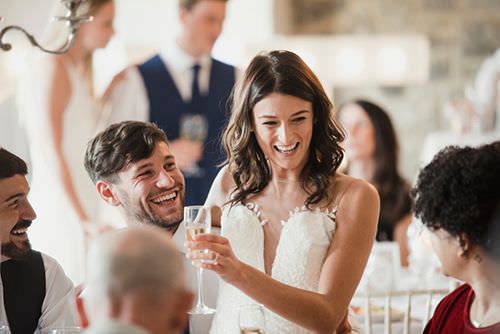 Newly weds laughing during reception.