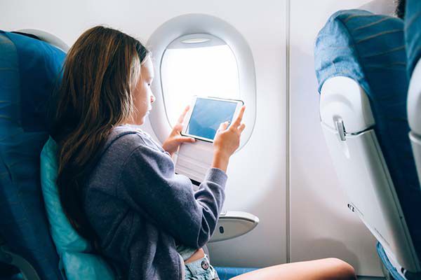 Plane passenger watching video on Mobile phone.