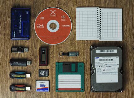 A collection of USB drives, SD cards, Hard drives, and floppy drives